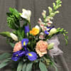 A small selection of blooms in a small bud vase, with the