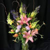 Recycled glass vase (style may vary) holds a winter / spring assortment.