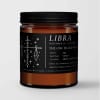 Amber candle in a black-lidded jar with a Libra label