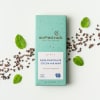 Mint chocolate bar with cocoa nibs and mint leaves