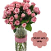 Pink roses arranged in a clear glass vase with a pink ribbon