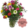 Mixed colorful flowers arranged in a clear glass vase