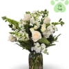 White roses and mixed white flowers in a glass vase