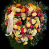 This heart funeral wreath features roses, red Hypericum with a very perfect