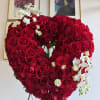 This heart funeral wreath features roses, mini phalaenopsis orchids 