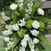 A beautiful, standing spray with assorted green and white premium flowers on