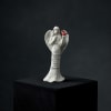 White angel figurine holding a red cardinal with memorial text