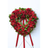 Heart-shaped red rose wreath on a stand with ribbon tails