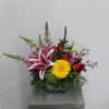 Mixed bouquet in a glass vase with a yellow gerbera and pink lily