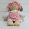 Plush doll in pink outfit with "My First Dolly" embroidery