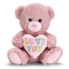 Pink plush teddy bear holding a pastel heart pillow with the words LOVE YOU.