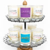 Set of scented candles in glass jars on a two-tier wire stand