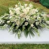 All white Casket , includes, roses, hydrangea, snapdragons, and greenery 