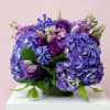 Purple and blue hydrangea bouquet in a glass vase