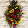 Tall mixed bouquet with red roses, sunflowers, and purple flowers