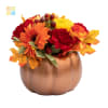 bronze ceramic pumpkin filled with an assortment of fall flowers
