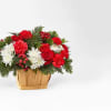 Basket created with holiday greens, red carnations, red roses, red hypericum berries