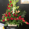 24 red roses with white snapdragon and a mixture of greens 