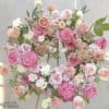 Large pastel floral arrangement with pink and peach roses