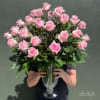 Large bouquet of pink roses in a clear glass vase