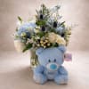 Pale blue hydrangeas and soft white roses create a gentle, celebratory look
