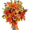 Orange lilies and roses with yellow daisies in a ribbon-tied bouquet