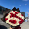 Bouquet of red and white roses wrapped in black paper