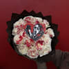 Bouquet of white roses with red splatter accents and a horror movie heart topper
