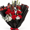 Bouquet of red roses with black wrapping and a horror mask topper