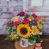 Sunflower bouquet in a mug with a small bee figurine