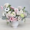 This stunning floral arrangement features a beautiful blend of pastel colors, with
