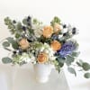 The Cora is a captivating arrangement that balances elegance with whimsy. Soft