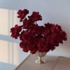 Red roses arranged in a decorative silver vase