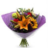 Bouquet with orange lilies, sunflowers, and mixed blooms wrapped in purple paper