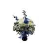 Blue and white mixed flower arrangement in a dark vase with ribbon