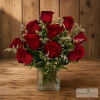 Red roses arranged in a clear square vase
