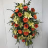 Tall floral spray with orange daisies and pale yellow lilies