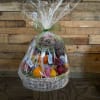 Wrapped fruit basket with oranges, apples, grapes, and candy bars