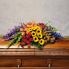 Colorful floral spray on a wooden casket