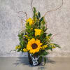 Sunflower and yellow rose arrangement in a black deer-print container