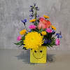 Colorful bouquet in a yellow smiley-face vase with a peach rose and yellow chrysanthemum