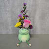 Pink rose and mixed daisy bouquet in a frog-shaped vase