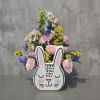 Mixed pastel flowers arranged in a bunny-shaped container