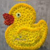Duck-shaped floral arrangement made of yellow flowers with a red flower beak.