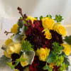 Bouquet of yellow roses and dark burgundy dahlias with silvery foliage