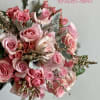 Pink rose bouquet with silver foliage and small filler flowers