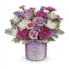Bouquet of pink and lavender flowers in a glittery purple vase