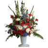 A bold mix of red, white, and blue seasonal blooms arranged in