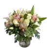 Bouquet of white lilies and pale pink roses in a clear glass vase