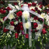 Large red and white floral spray with a sheer ribbon bow